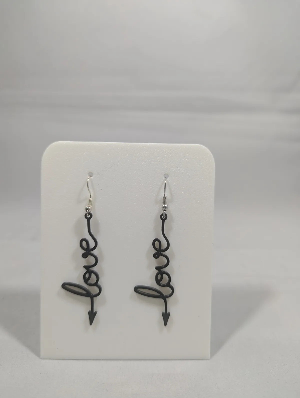 LOVE arrow earrings worn